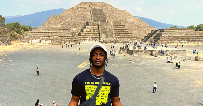Student posing in front of a pyramid in Mexico