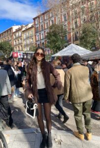Global Ambassador posing for a photo while shopping at an outdoor market in Madrid.