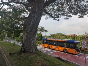 Blue and orange shuttle bus driving through Singapore