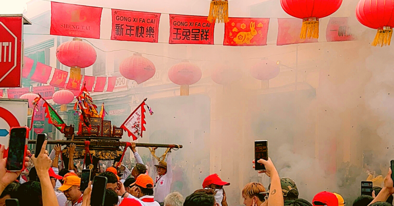 Smoke covers an outdoor market during a festival.