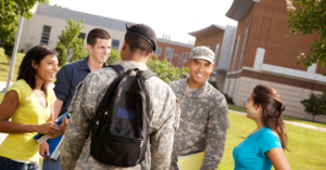 Student in green and while military uniform smiles outside a university