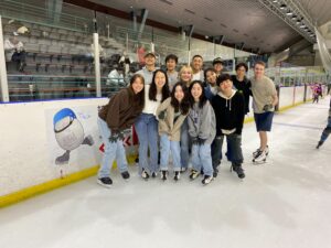 Photo of students smiling while ice skating