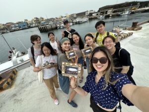 Selfie of group of international and exchange students smiling near ocean