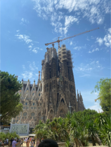 Large gothic structure with a construction cane in back and a cloudy sky 