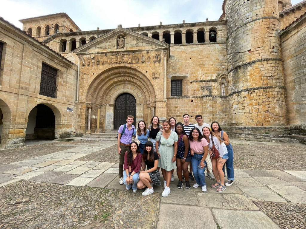 Students pose in a historic courtyard