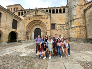 Students post in a historic courtyard