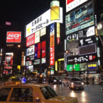 The bustling city in Asia is full of cabs, cars, billboards and foot traffic.