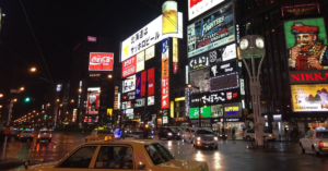 The bustling city in Asia is full of cabs, cars, billboards and foot traffic.