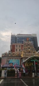 The city scape is in full view in this vertical shot of buildings behind buildings. 