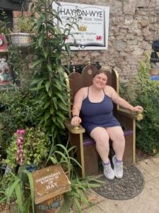 A student sitting on a wooden bench in Hay-on-Wye, Britain, during a visit to the world's first book town.