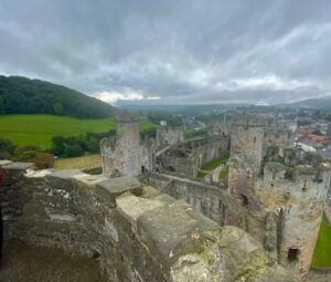 Scenic view from the top turret of Conwy Castle in Conwy, Wales, showcasing the historic architecture, stone walls, and picturesque landscape