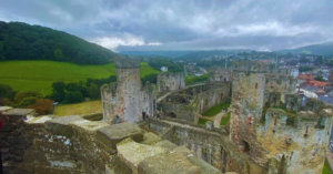 Scenic view from the top turret of Conwy Castle in Conwy, Wales, showcasing the historic architecture, stone walls, and picturesque landscape