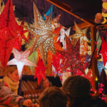 Many Star Christmas lights at a holiday market illuminate the stall