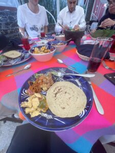 Many types of traditional Mexican food on a colorful table.
