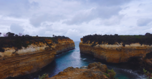 Two rock formations cushion a straight of water that leads to open ocean