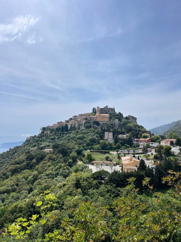 A historic city on a hill with partly cloudy sky in the background