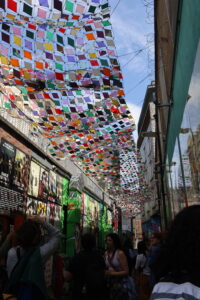 Colorful banner hanging from building, vibrant hues catch attention