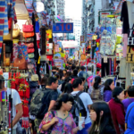 A busy street filled with tourists and outdoor shops.