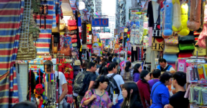 A busy street filled with tourists and outdoor shops.