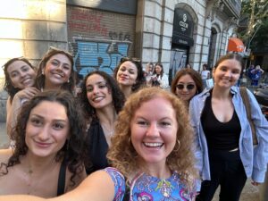 A group of students takes a selfie while on the street.