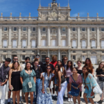 A large group of students outside of Madrid's historic palace.