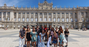 A large group of students outside of Madrid's historic palace.