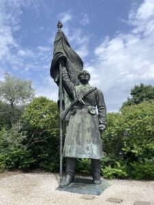 A statue of a man holding a flag.