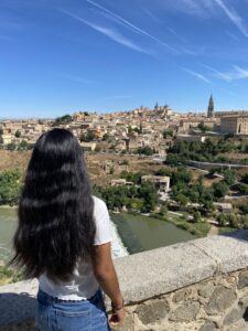 The back of a student while she overlooks the vast historic city