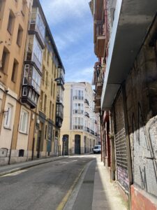 Buildings on both sides of a cobblestone street during the day