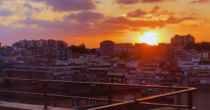 The sunset going down behind the photos of a European city