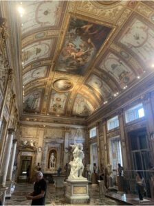 The roof of a historic Roman building displays hand-painted art.