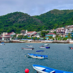 Several boats fill up the bay of a local beach town