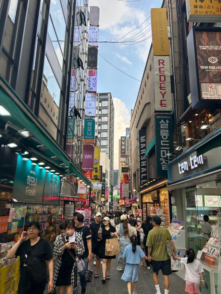 Clothing shops, souvenir stores and food vendors fill Myeongdong, a popular destination for tourists.