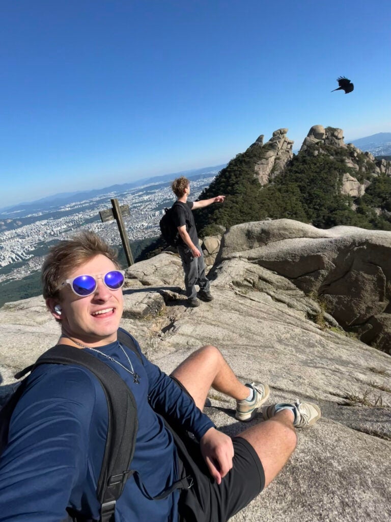 My friend from France pointing at a bird on the highest peak at Bukhansan National Park.