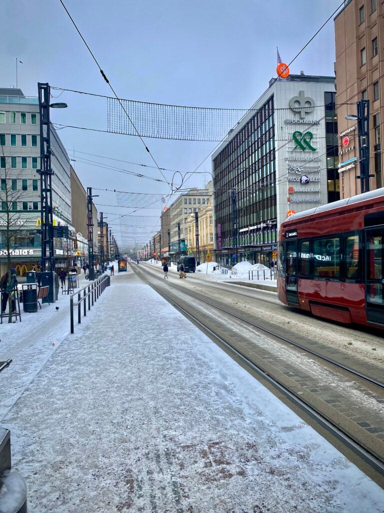 My local tram stop, Rautatieasema. Snow and buildings in view.