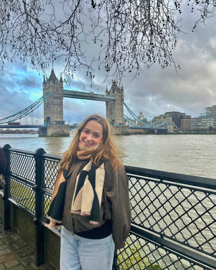 Viviana standing along the banks with the famous London Tower Bridge and river Thames in view.