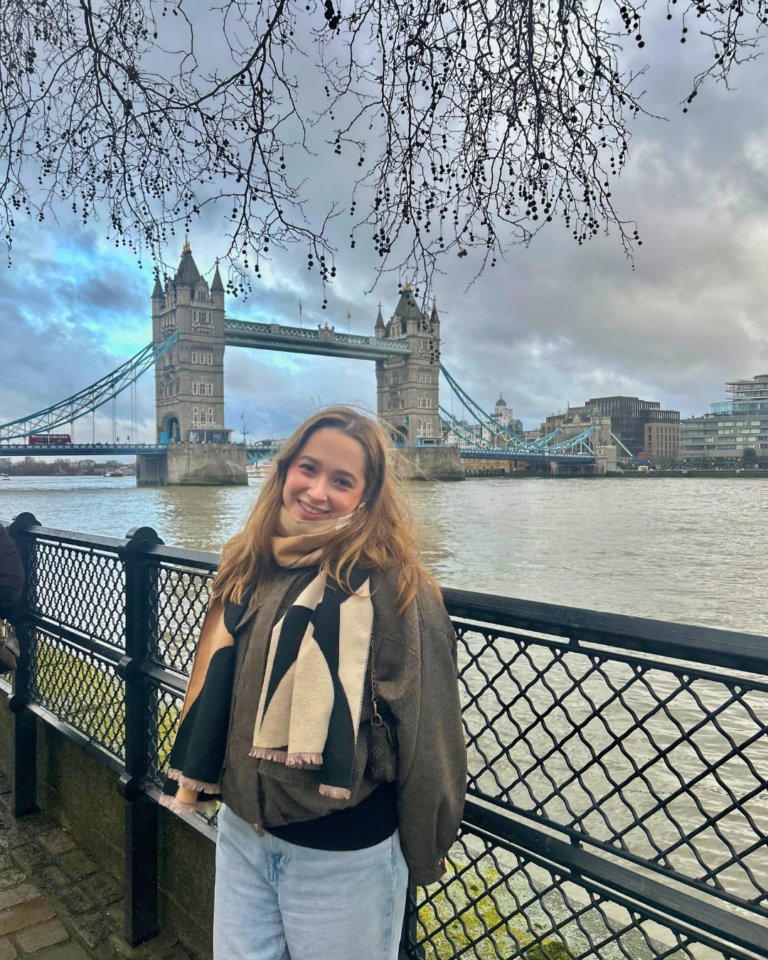 Viviana standing along the banks with the famous London Tower Bridge and river Thames in view.